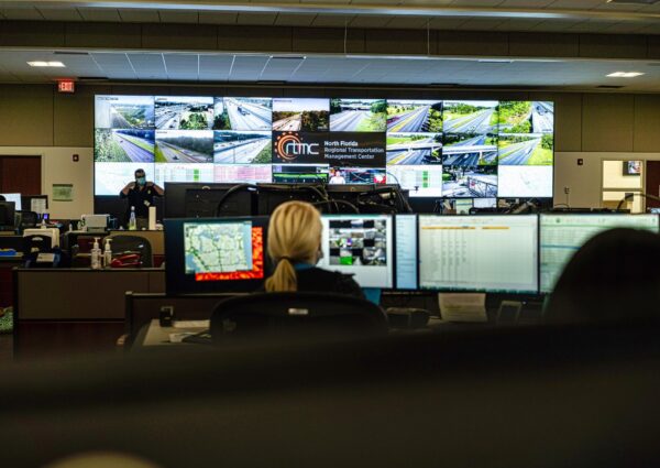 Interior of the North Florida RTMC facility showing operator workstations and traffic monitoring screens